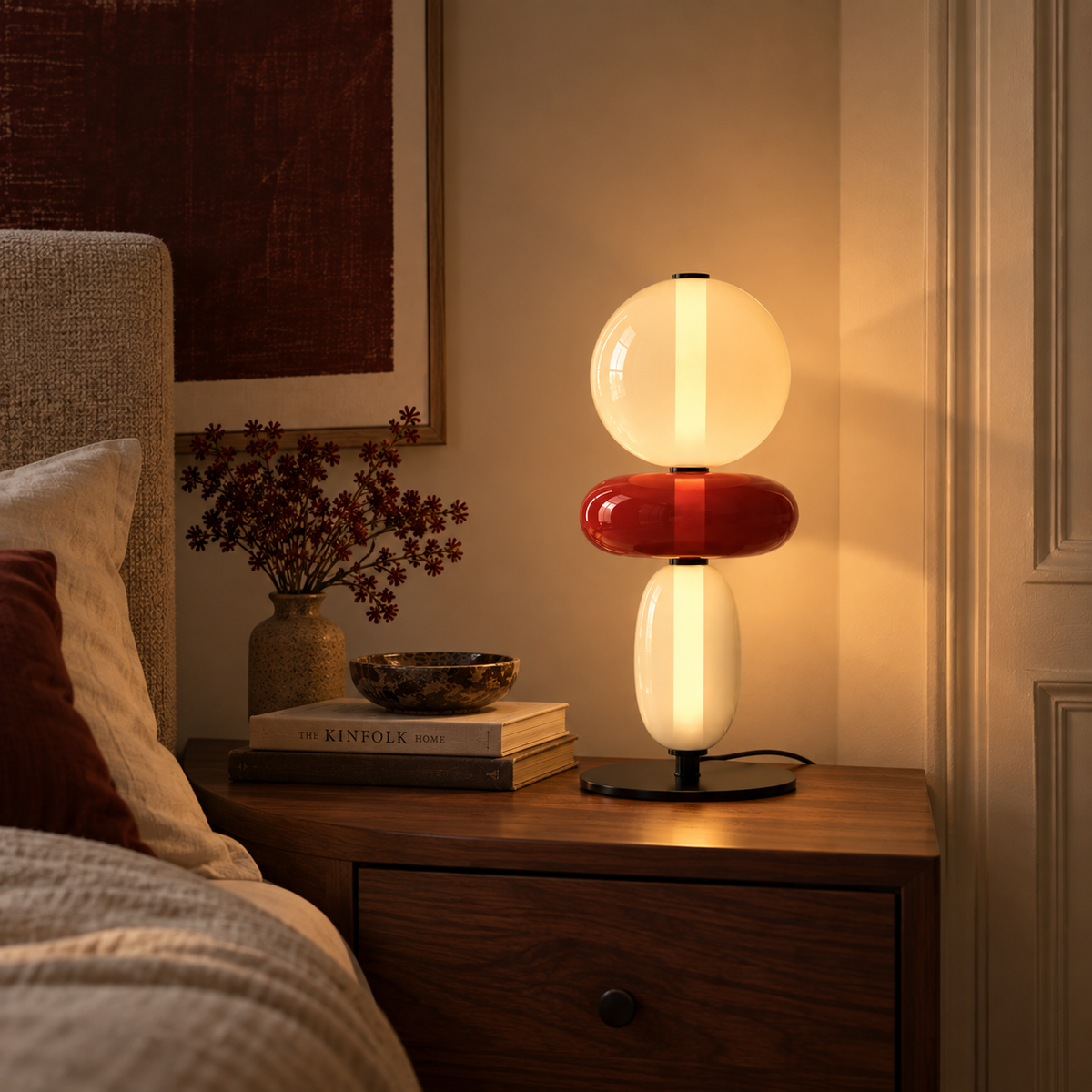Stacked glass totem table lamp on a marble worktop