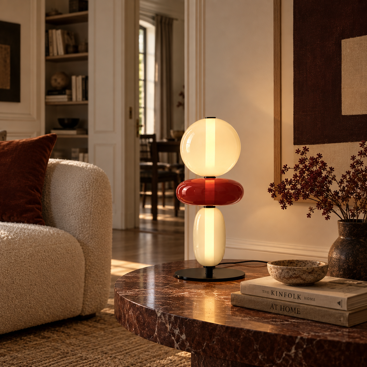 Stacked glass totem table lamp beside a sofa