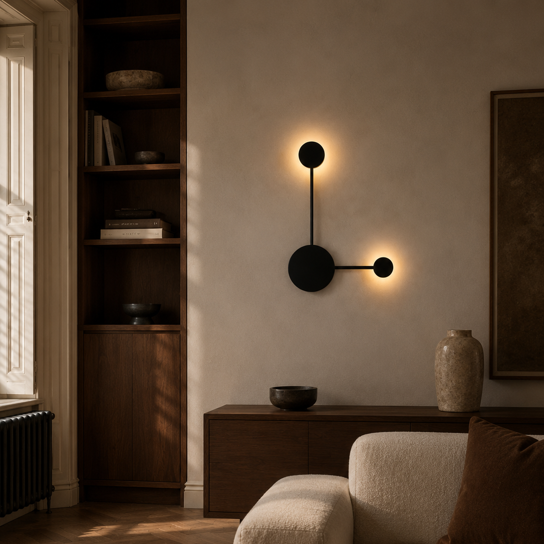 Black two-head LED wall light above a boucle armchair in a period living room