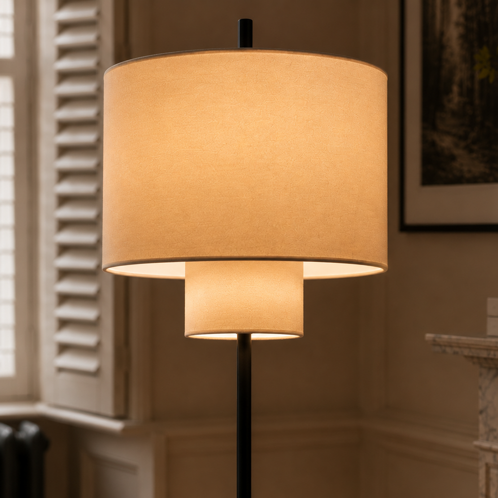 Pebble floor lamp glowing beside a shuttered window