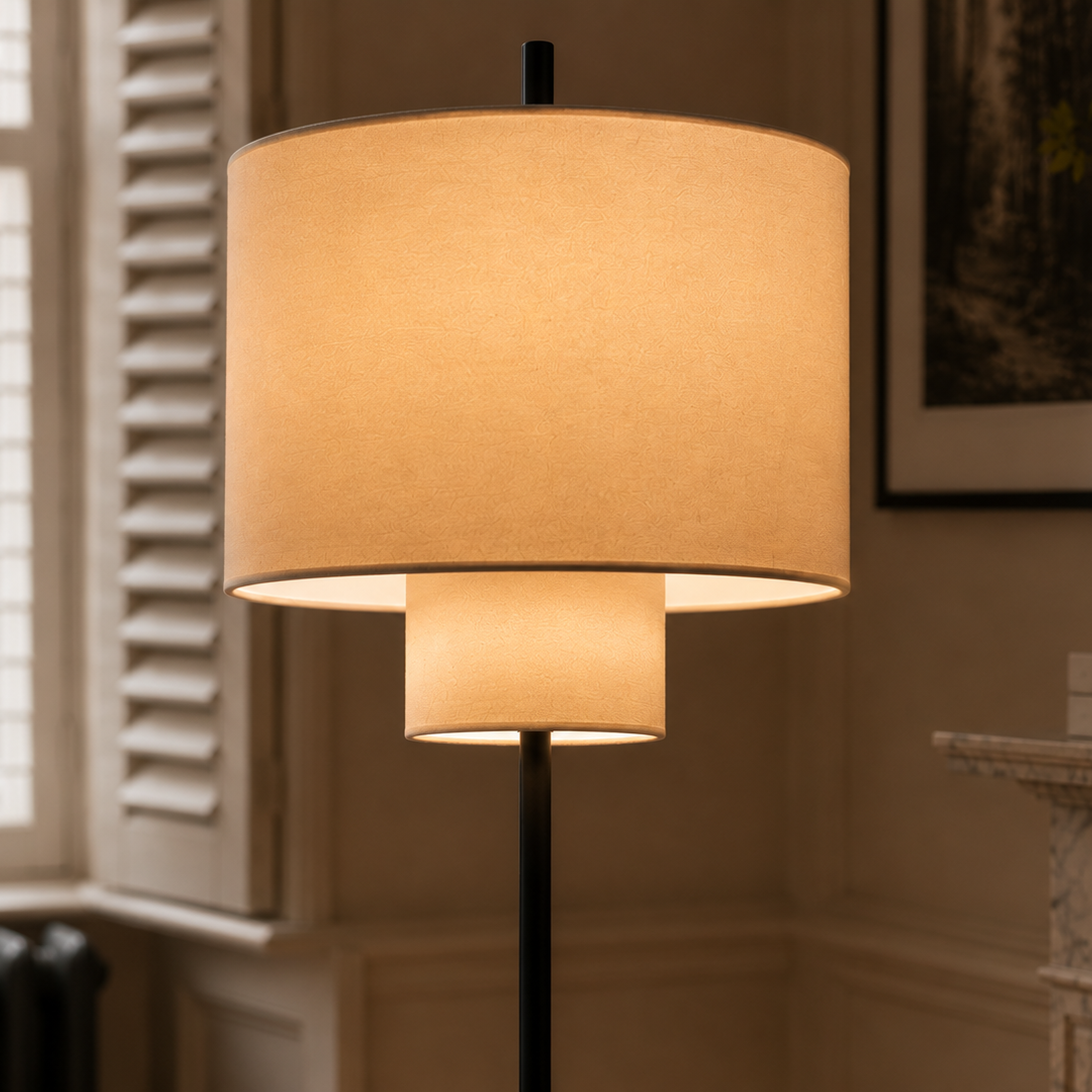Pebble floor lamp glowing beside a shuttered window