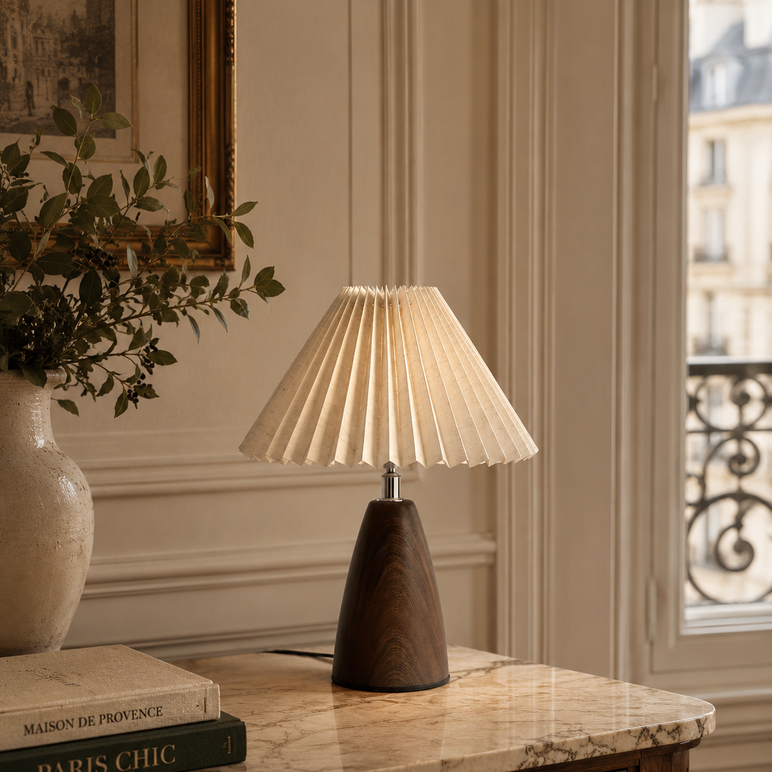 Pleated shade table lamp beside a plant on a marble console