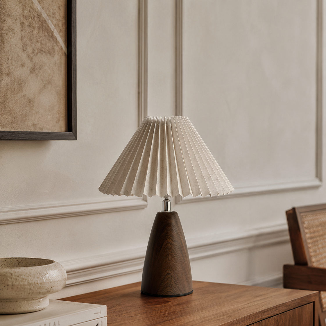 Pleated shade table lamp with a walnut base on a console table