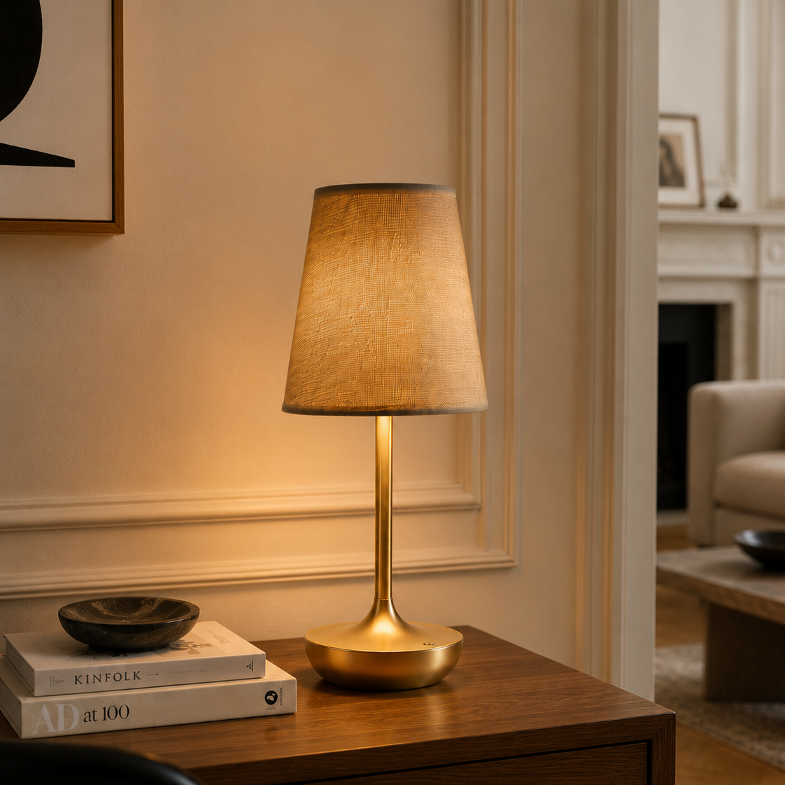 Rechargeable fabric-shade table lamp on a console beside an armchair